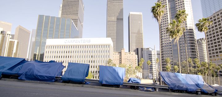  Tarps tightened in between a fence and a guard rail in Los Angeles 